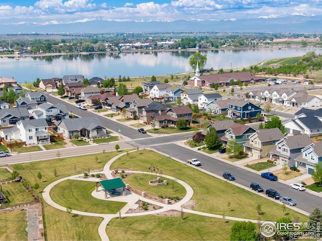 aerial view of residential area featuring a large body of water
