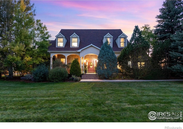 new england style home with a front lawn and a porch