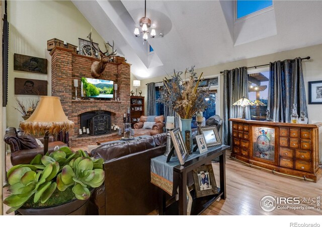 living room with high vaulted ceiling and wood finished floors