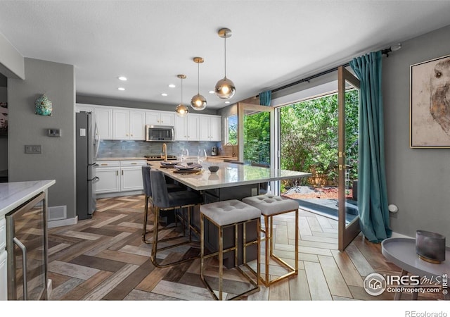 dining room featuring beverage cooler and recessed lighting
