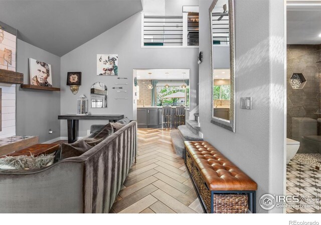 living area featuring high vaulted ceiling