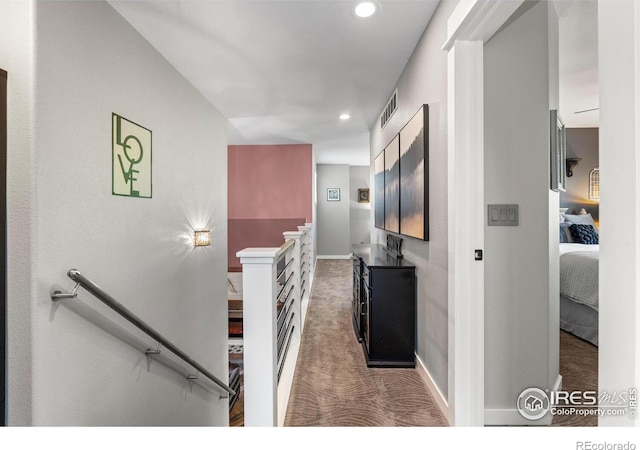corridor featuring an upstairs landing, carpet flooring, recessed lighting, and baseboards