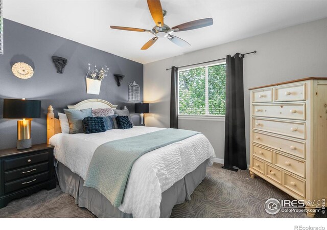 carpeted bedroom with a ceiling fan and baseboards