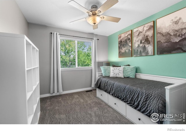carpeted bedroom with a ceiling fan and baseboards