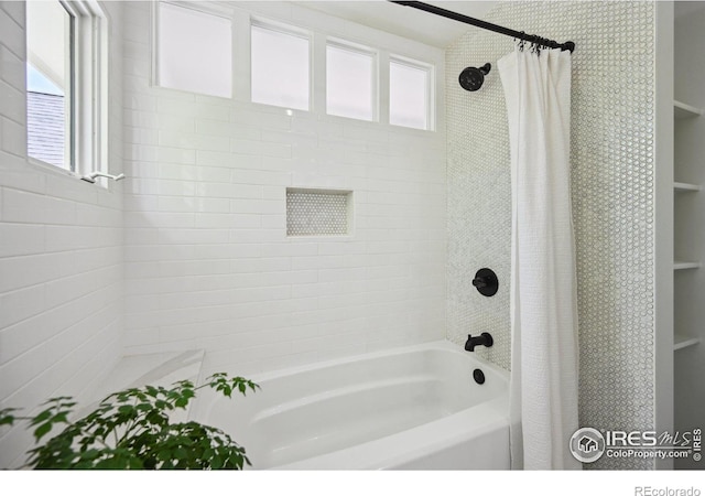 bathroom with shower / bath combination with curtain