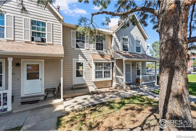 504 Shady Crest Cir, Colorado Springs, CO 80916 - townhome / multi-family property with a porch, roof with shingles, and cooling unit