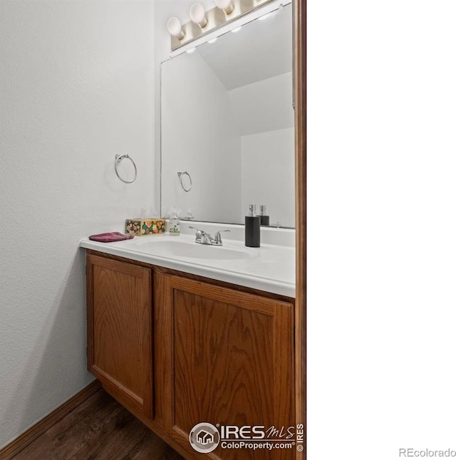504 Shady Crest Cir, Colorado Springs, CO 80916 - bathroom featuring wood finished floors, vanity, and a textured wall