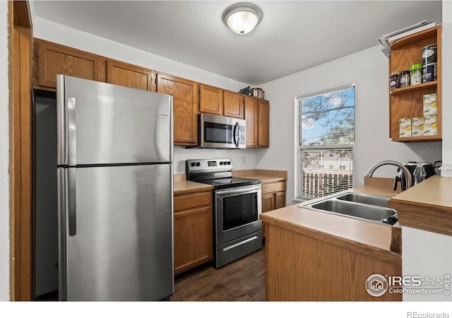 504 Shady Crest Cir, Colorado Springs, CO 80916 - kitchen featuring appliances with stainless steel finishes, a sink, open shelves, light countertops, and brown cabinetry