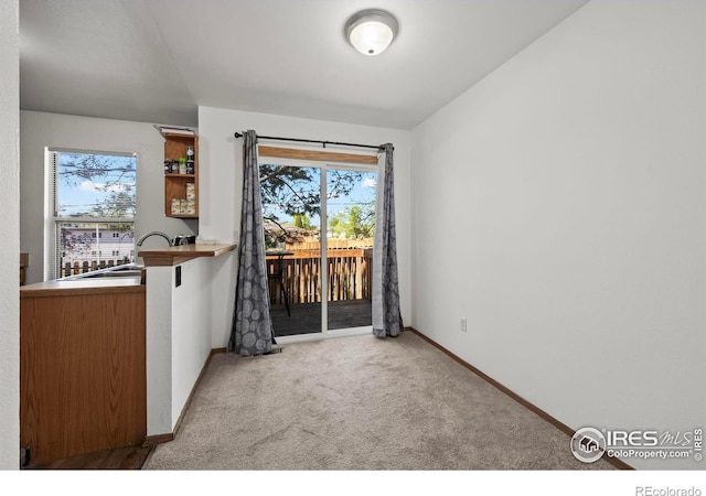 504 Shady Crest Cir, Colorado Springs, CO 80916 - unfurnished dining area with a sink, carpet, and baseboards