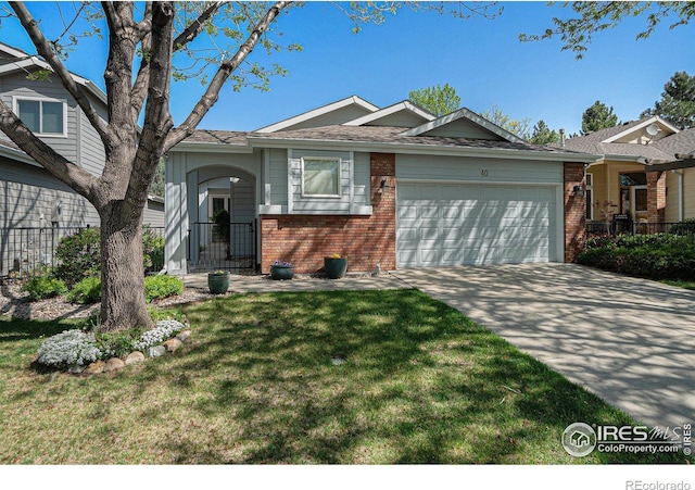 view of front facade with brick siding, an attached garage, a front yard, and concrete driveway