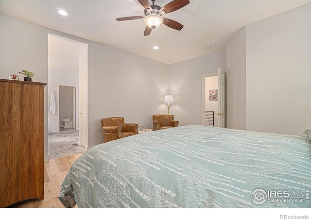 bedroom with wood finished floors, recessed lighting, connected bathroom, and ceiling fan
