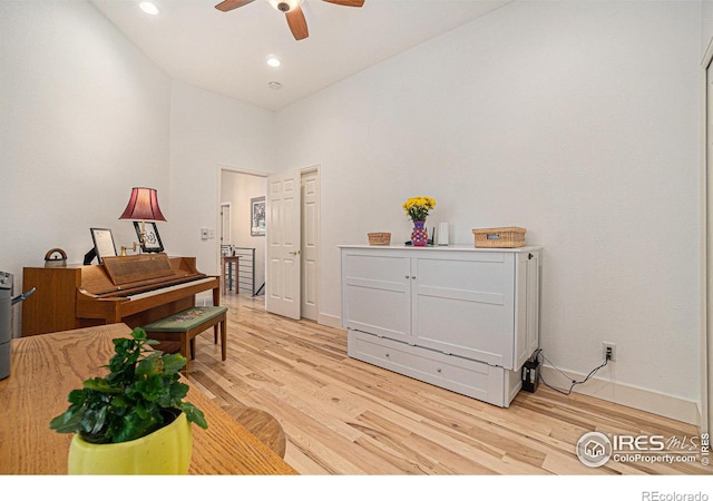 living area featuring a ceiling fan, light wood finished floors, baseboards, and recessed lighting