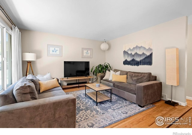 living room with wood finished floors and baseboards