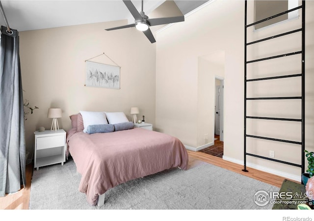 bedroom with wood finished floors and baseboards