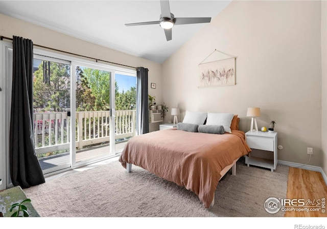 bedroom featuring access to exterior, vaulted ceiling, wood finished floors, baseboards, and a ceiling fan