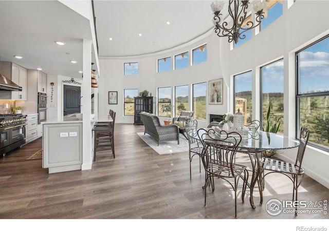 2118 Dry Creek Dr, Lyons, CO 80540 - dining room featuring healthy amount of natural light, recessed lighting, a high ceiling, dark wood finished floors, and a chandelier