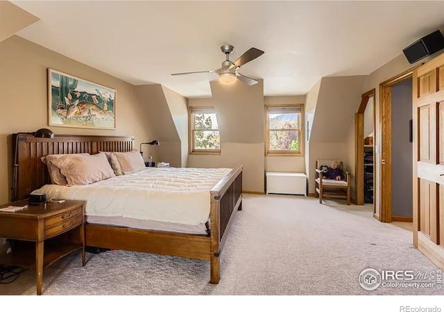 bedroom featuring light colored carpet, ceiling fan, and baseboards