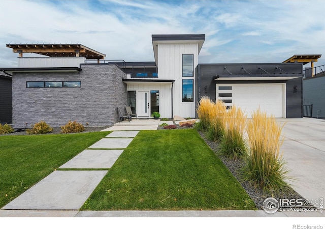 contemporary house with driveway, an attached garage, a front lawn, and board and batten siding