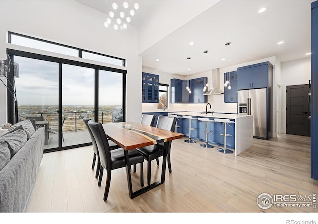 dining space with light wood-style floors and recessed lighting