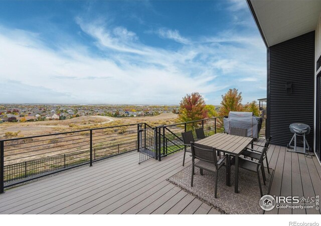 wooden terrace featuring outdoor dining area