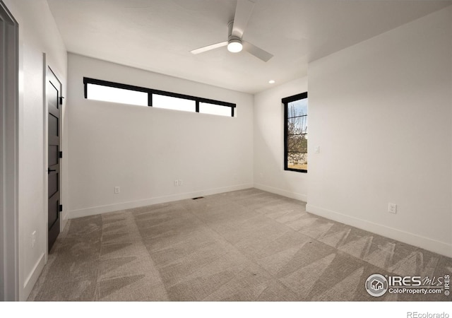 unfurnished room with a ceiling fan, carpet flooring, and baseboards