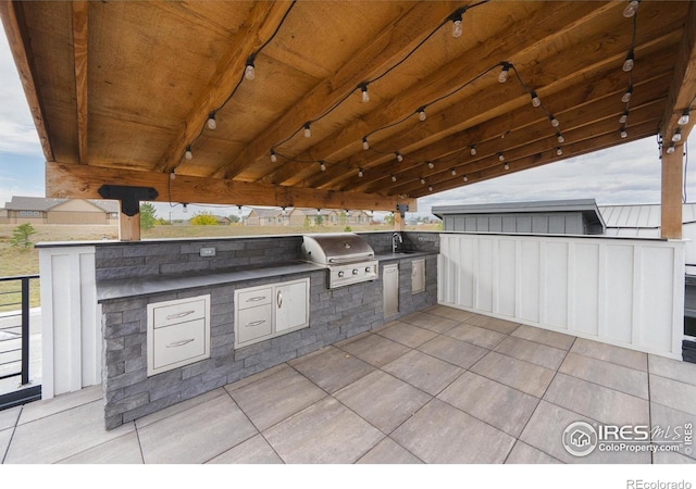 view of patio featuring area for grilling, an outdoor kitchen, and a sink