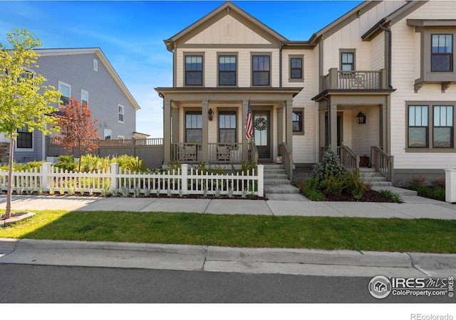 97 Westerly Blvd, Erie, CO 80516 - view of front of property with board and batten siding, a porch, and a fenced front yard
