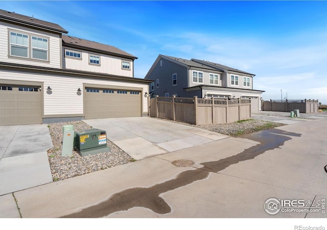 97 Westerly Blvd, Erie, CO 80516 - view of front facade with fence, concrete driveway, and a garage