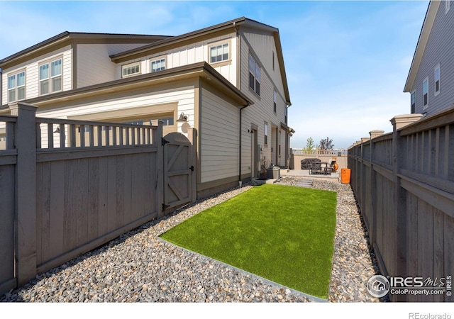 97 Westerly Blvd, Erie, CO 80516 - view of property exterior with a gate, a fenced backyard, and a patio area