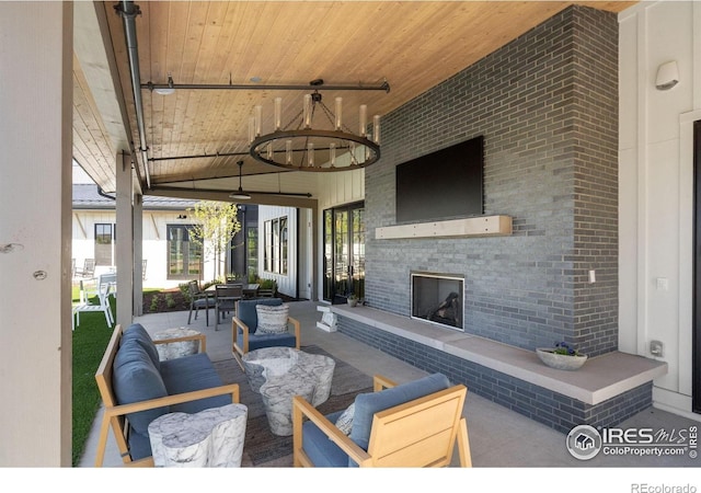 97 Westerly Blvd, Erie, CO 80516 - view of patio / terrace with an outdoor living space with a fireplace