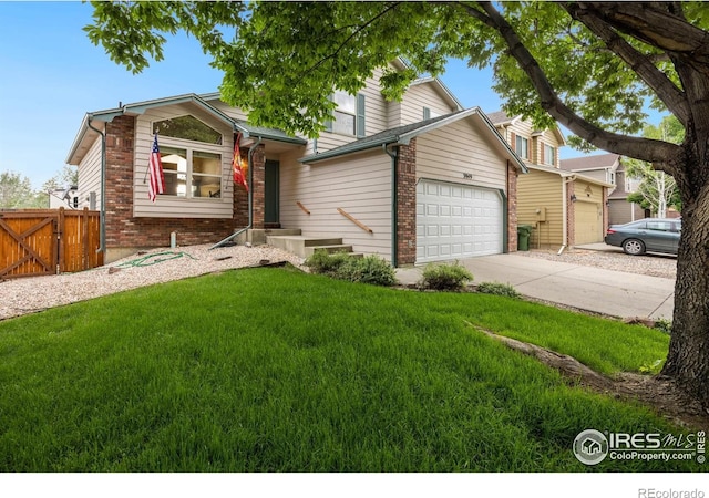 3949 Willowood Ave, Loveland, CO 80538 - view of front of house with brick siding, an attached garage, driveway, and a gate