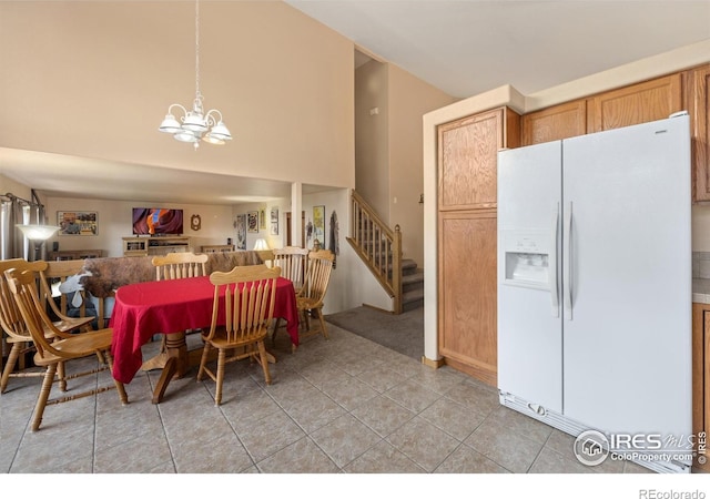 3949 Willowood Ave, Loveland, CO 80538 - dining room featuring a chandelier, stairway, light tile patterned flooring, and a high ceiling