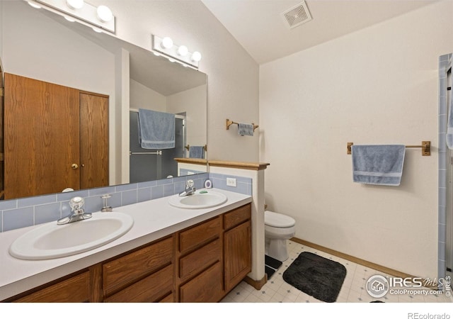 3949 Willowood Ave, Loveland, CO 80538 - full bath with vaulted ceiling, a stall shower, double vanity, toilet, and tile patterned floors