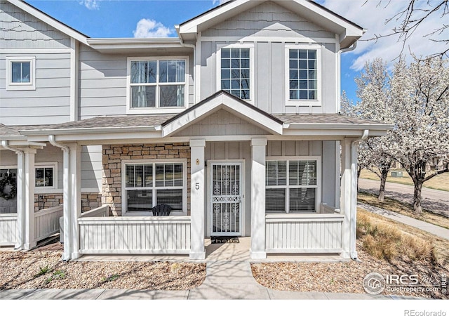 3623 29th St Unit 5, Greeley, CO 80634 - view of front of house featuring covered porch, board and batten siding, and roof with shingles