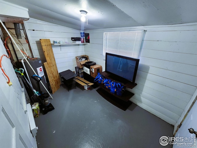 below grade area featuring water heater and wooden walls