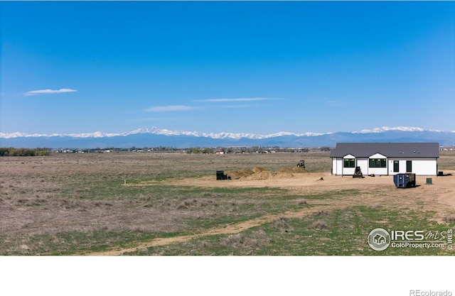 view of mountain background featuring rural landscape