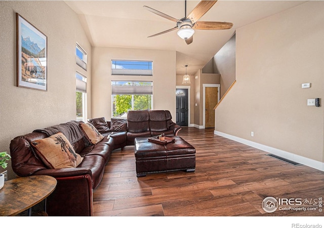 8962 Smoke Signal Way, Wellington, CO 80549 - living area with wood finished floors, ceiling fan, a towering ceiling, and baseboards