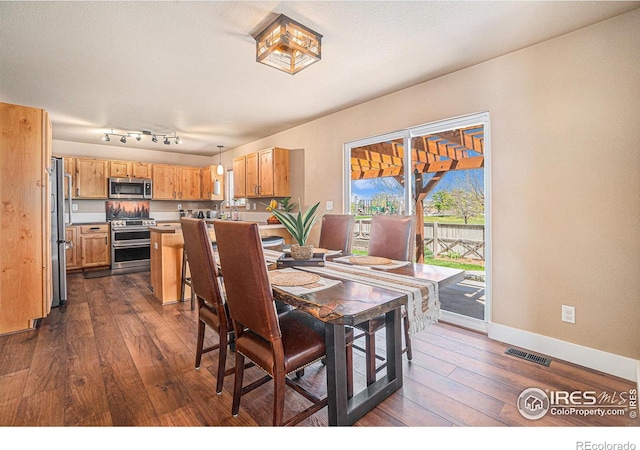 8962 Smoke Signal Way, Wellington, CO 80549 - dining room with dark wood-type flooring and baseboards