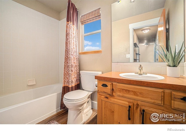 8962 Smoke Signal Way, Wellington, CO 80549 - bathroom with toilet, vanity, shower / bath combination with curtain, and wood finished floors