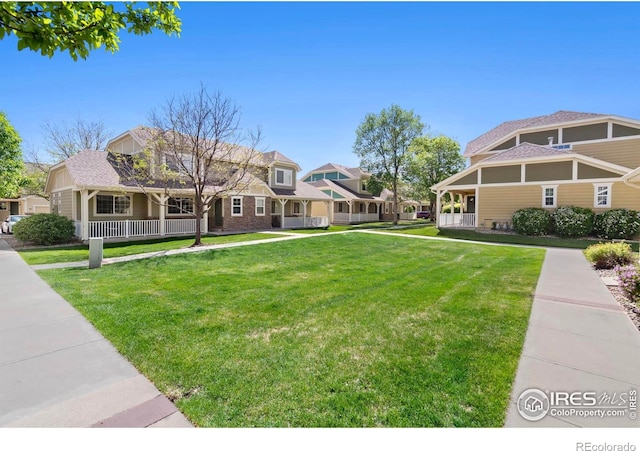 1014 Andrews Peak Dr Unit B107, Fort Collins, CO 80521 - view of green lawn featuring a porch