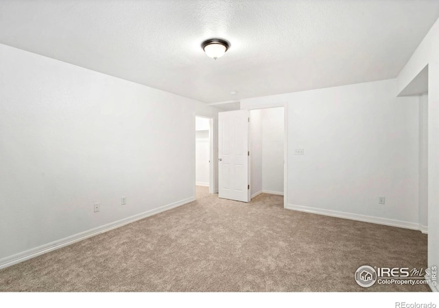 1014 Andrews Peak Dr Unit B107, Fort Collins, CO 80521 - unfurnished bedroom featuring carpet, a textured ceiling, and baseboards