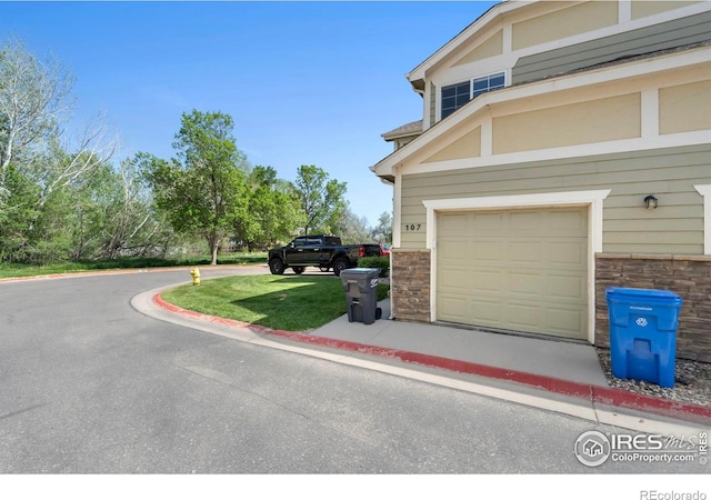 1014 Andrews Peak Dr Unit B107, Fort Collins, CO 80521 - view of side of property with stone siding and an attached garage