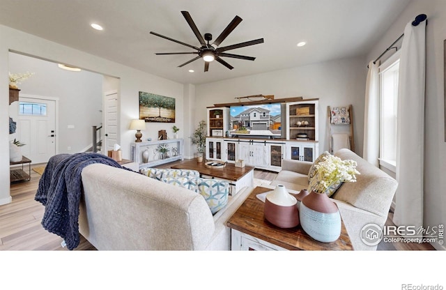living room with ceiling fan, wood finished floors, and recessed lighting