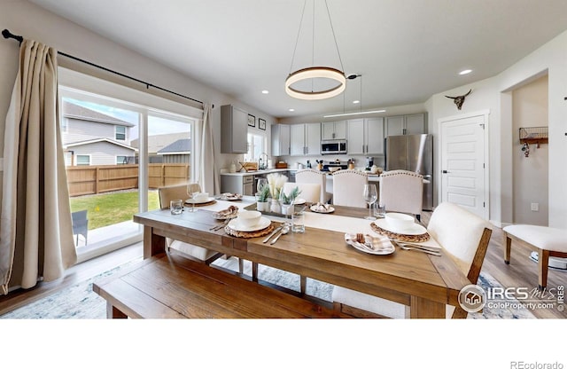 dining space featuring light wood-style floors and recessed lighting