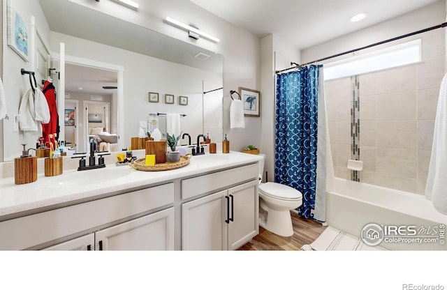 bathroom with double vanity, toilet, wood finished floors, ensuite bath, and shower / tub combo