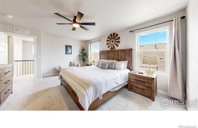 bedroom featuring light carpet, baseboards, and a ceiling fan