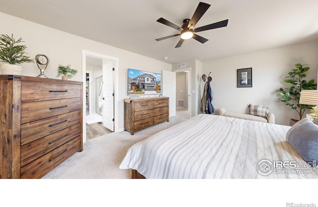 bedroom featuring carpet floors, ensuite bathroom, a ceiling fan, and baseboards