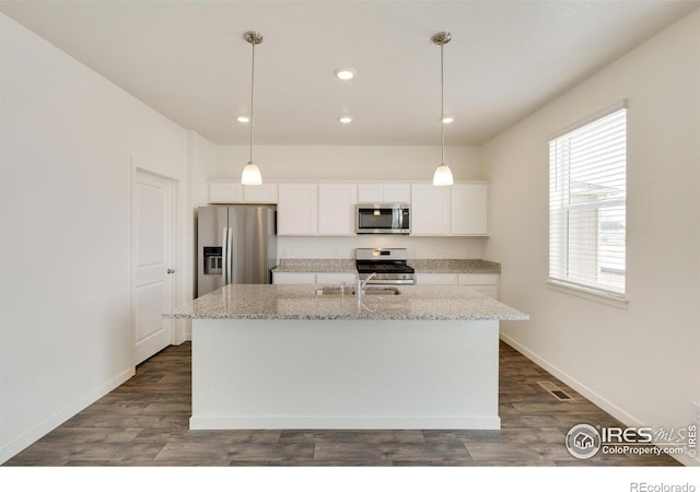 332 Hummingbird Ln, Johnstown, CO 80534 - kitchen featuring stainless steel appliances, white cabinetry, recessed lighting, a center island with sink, and dark wood finished floors