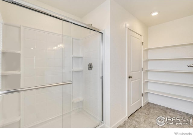 332 Hummingbird Ln, Johnstown, CO 80534 - bathroom featuring a stall shower, recessed lighting, and baseboards