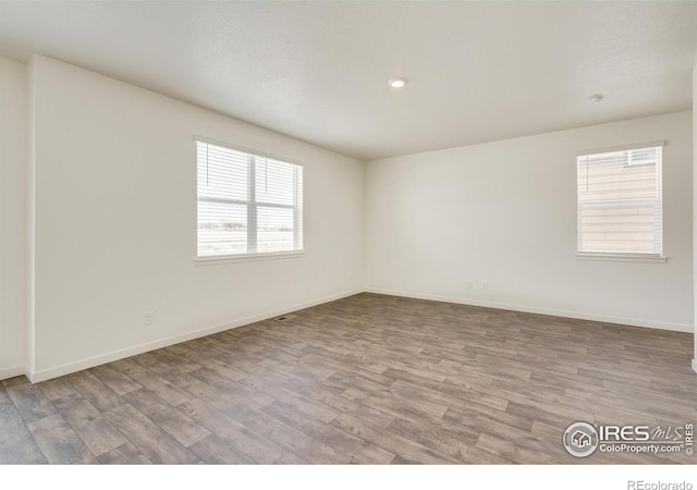 332 Hummingbird Ln, Johnstown, CO 80534 - empty room with wood finished floors, baseboards, and recessed lighting